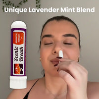 Woman using a Scenic Breath aromatic inhaler labeled 'Unique Lavender Mint Blend' against a neutral background.