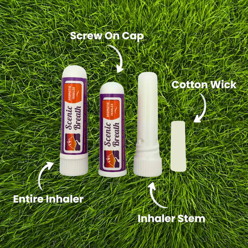 Scents of Breath inhaler components on grass with labels